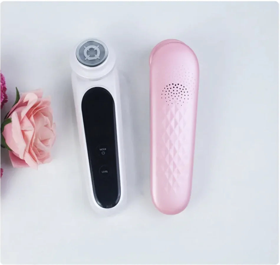 The white and pink EMS Microcurrent Beauty Devices lying side by side, with the pink device facing down and the white device facing up