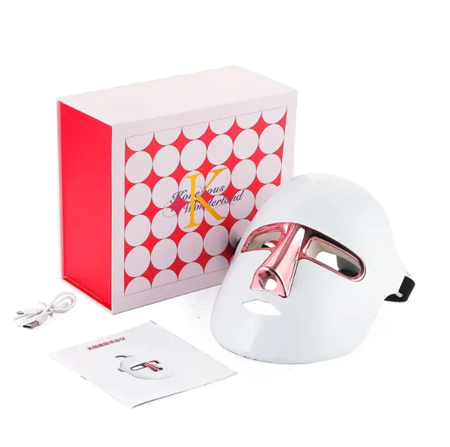 White LED facial mask with pink accents displayed with its pink box and charger.